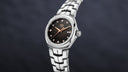 Luxury stainless steel TAG Heuer Link watch with diamond bezel, black dial, and silver band