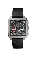Square-faced luxury men’s watch with black strap, skeleton dial, and red accents