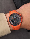 Omega x Swatch Moonswatch Mission on Earth watch with orange rubber strap on wrist