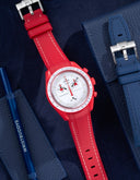 Red rubber strap for Omega x Swatch MoonSwatch Mission to Mars watch on blue background